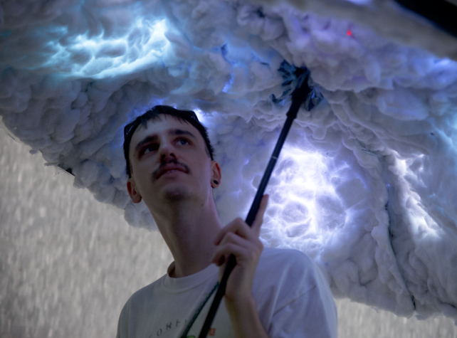 User holding umbrella under cotton lining