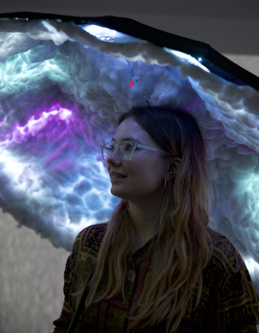 User looking at umbrella with coloured LEDs