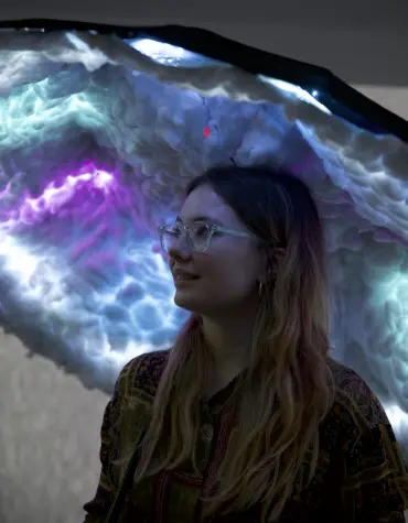 User looking at umbrella with coloured LEDs